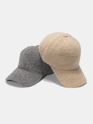 Textured sherpa baseball caps in gray and ivory with adjustable strap