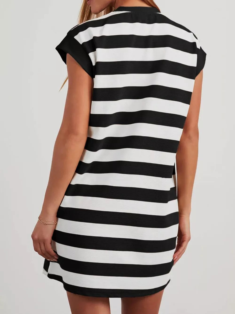 Black and white striped mini dress with cap sleeves and pockets.