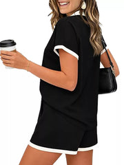 Black polo collar two-piece set with white trim on sleeves and shorts.