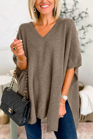 Relaxed V-neck knit poncho top in brown with side slits and short sleeves.