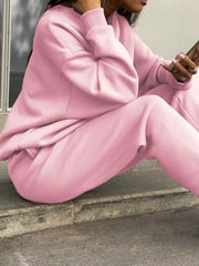 Blush pink athleisure sweatshirt and pants set with crewneck and cuffed sleeves.