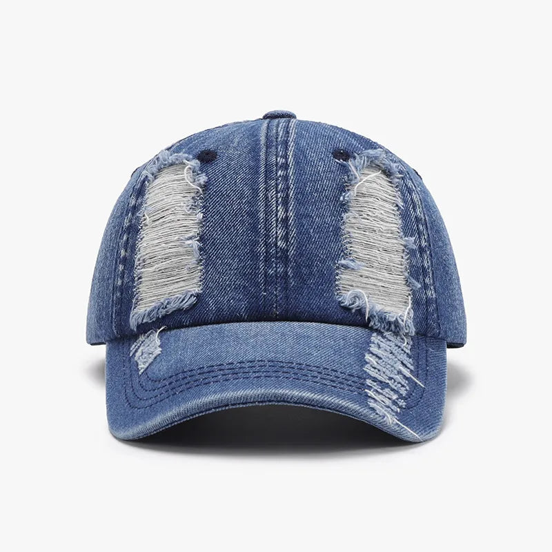 Denim baseball cap in light blue with distressed shredded details and a curved brim.