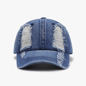 Denim baseball cap in light blue with distressed shredded details and a curved brim.