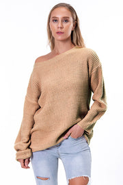 Tan off-shoulder waffle knit sweater with slouchy fit and boat neckline.