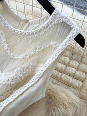 White tiered lace midi maternity dress with crochet trim and bow detail.