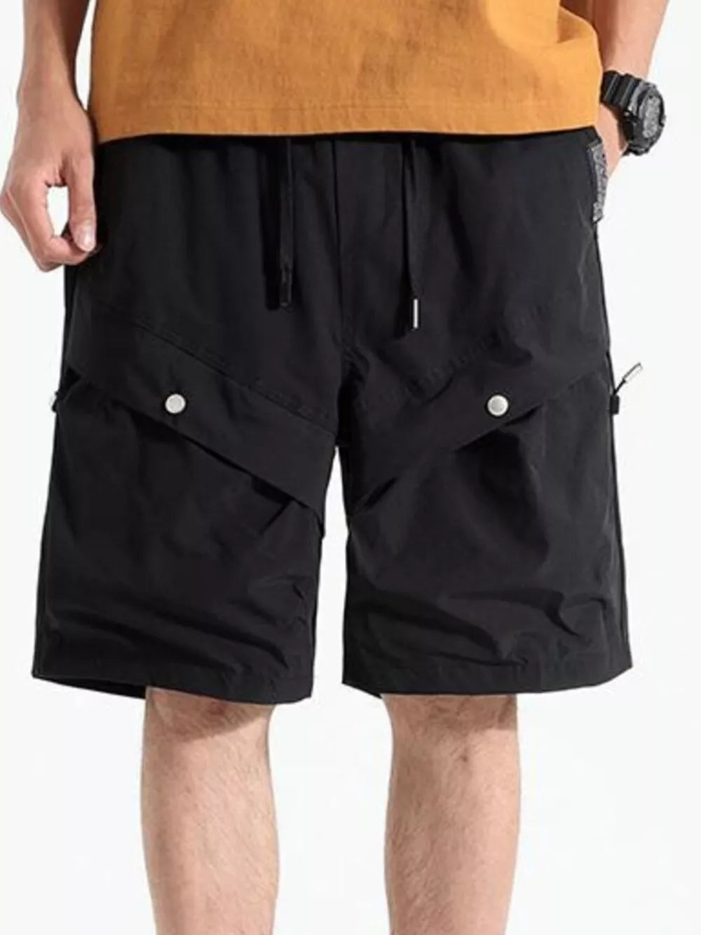 Black relaxed fit cargo shorts with drawstring waist and button flap pockets.