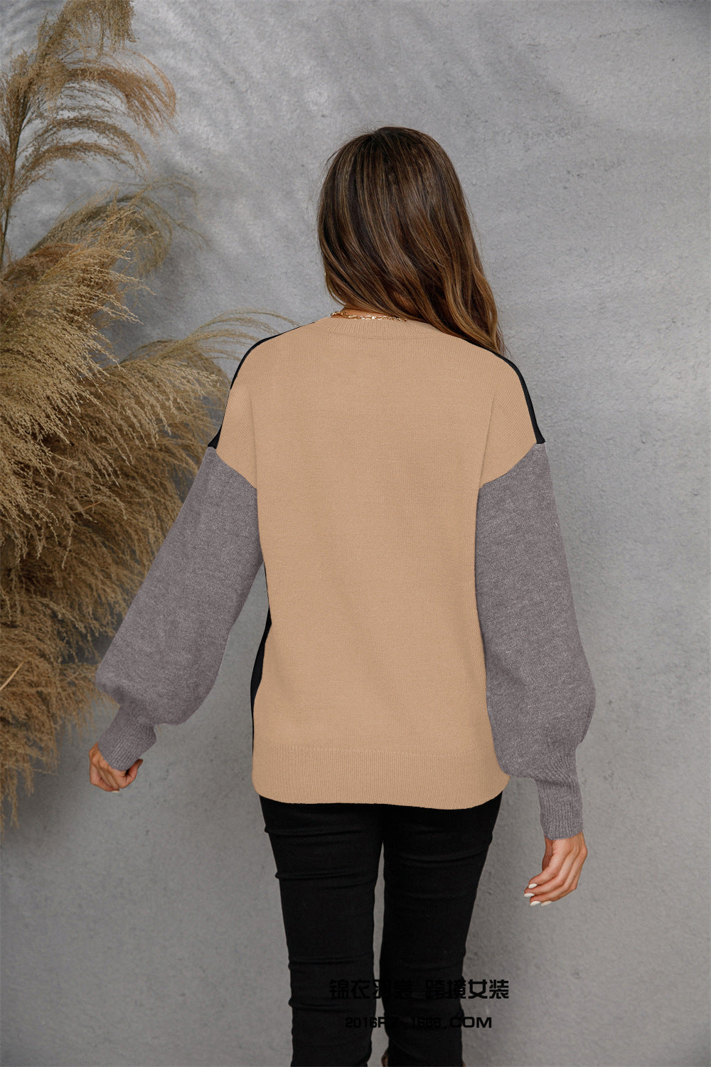 Colorblock knit sweater with beige body, grey sleeves, and black accents. Casual henley style.