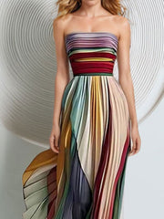 Pleated strapless maxi dress with a colorful striped bodice and skirt, featuring a dramatic silhouette.