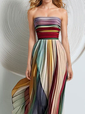 Pleated strapless maxi dress with a colorful striped bodice and skirt, featuring a dramatic silhouette.