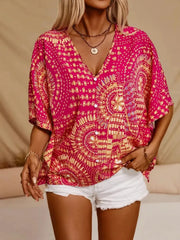 Bohemian print v-neck t-shirt in hot pink with short sleeves and button front, styled with white shorts.