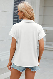 White textured polo top with cuffed short sleeves and a relaxed fit.