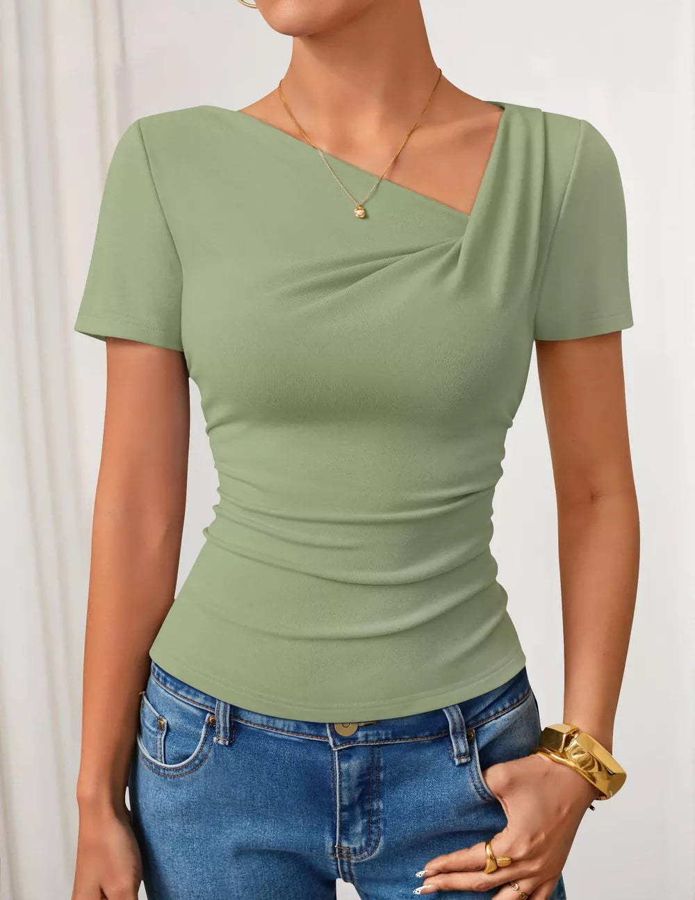 Green asymmetrical maternity t-shirt with draped neckline and short sleeves.