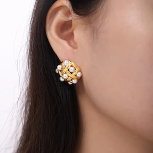Gold woven pearl grid earrings with a textured finish.