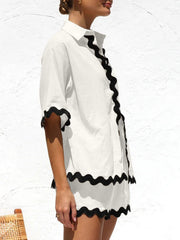 White linen co-ord set with black scalloped trim on shirt and shorts
