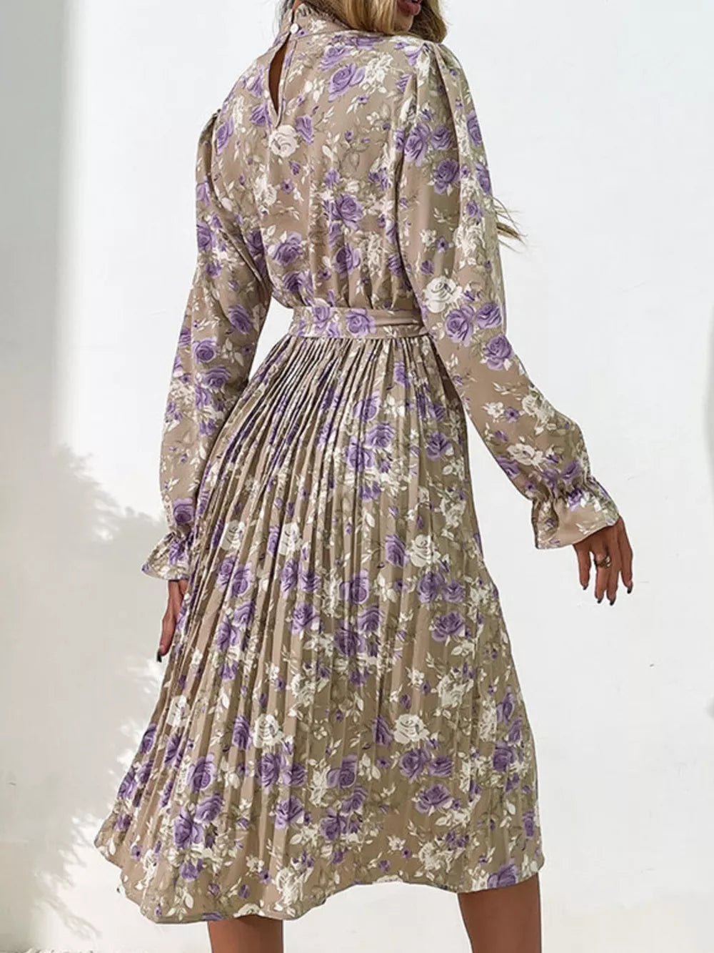 Elegant floral midi dress in khaki with purple roses, long sleeves, pleated skirt, and tie waist.