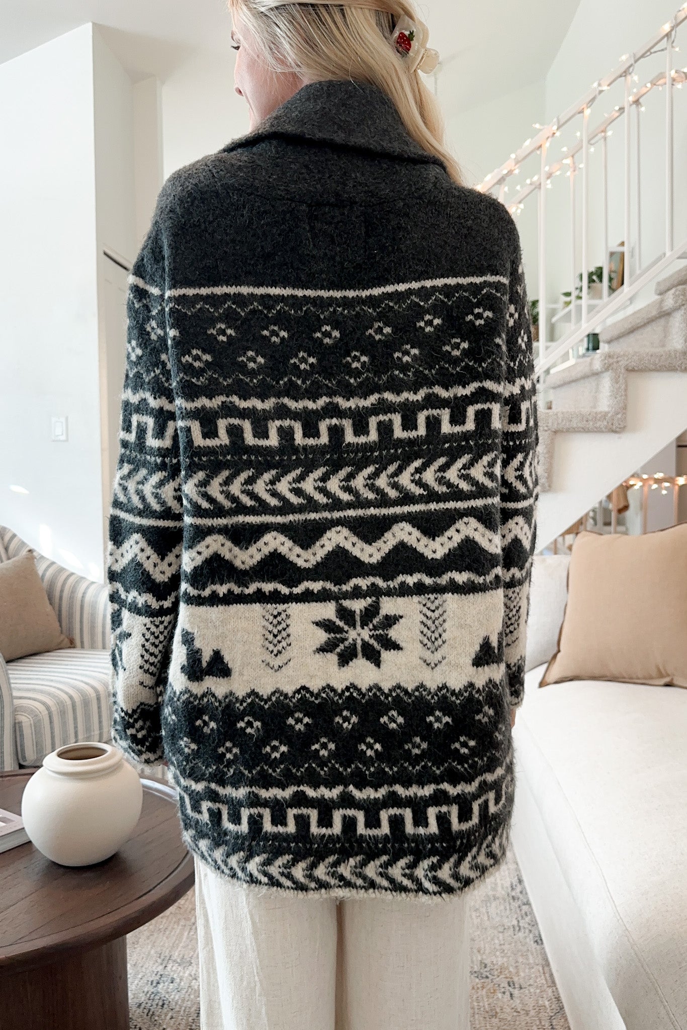 Black geometric jacquard wrap cardigan with shawl collar and belt detail.