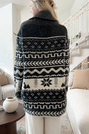 Black geometric jacquard wrap cardigan with shawl collar and belt detail.