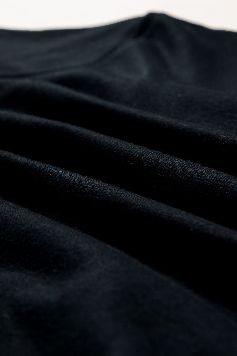 Black sweatshirt with fabric detail showing soft texture and subtle folds