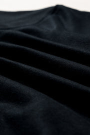 Black sweatshirt with fabric detail showing soft texture and subtle folds