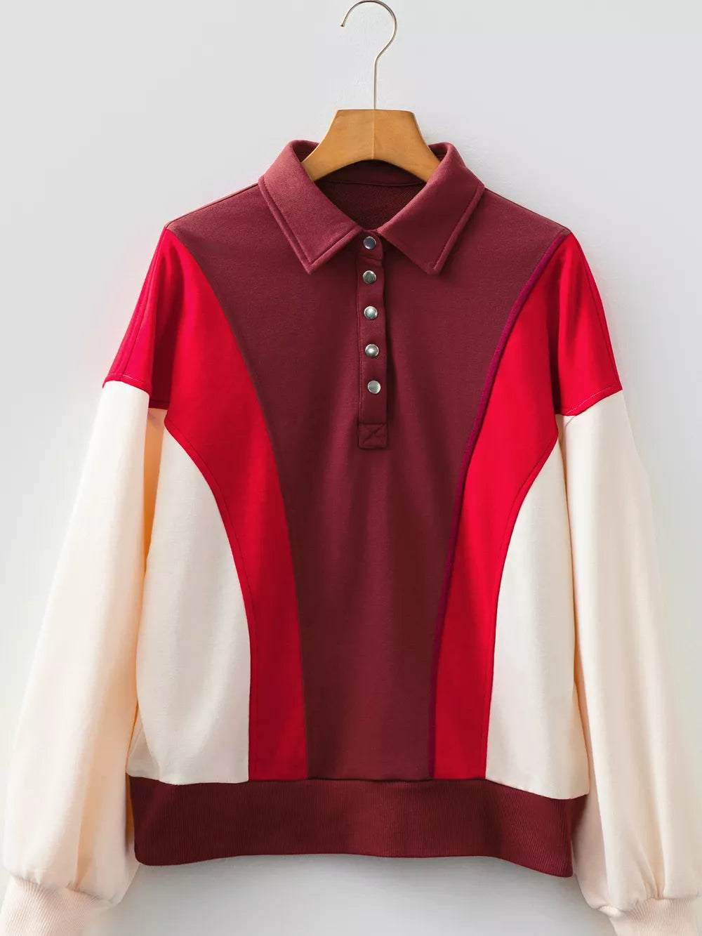 Color block cotton sweatshirt with buttoned collar and red, maroon, and cream panels.