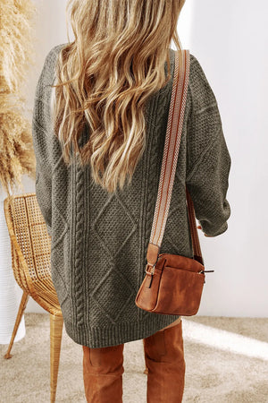 Cable knit sweater dress in sage with diamond pattern, crew neck, and long sleeves.