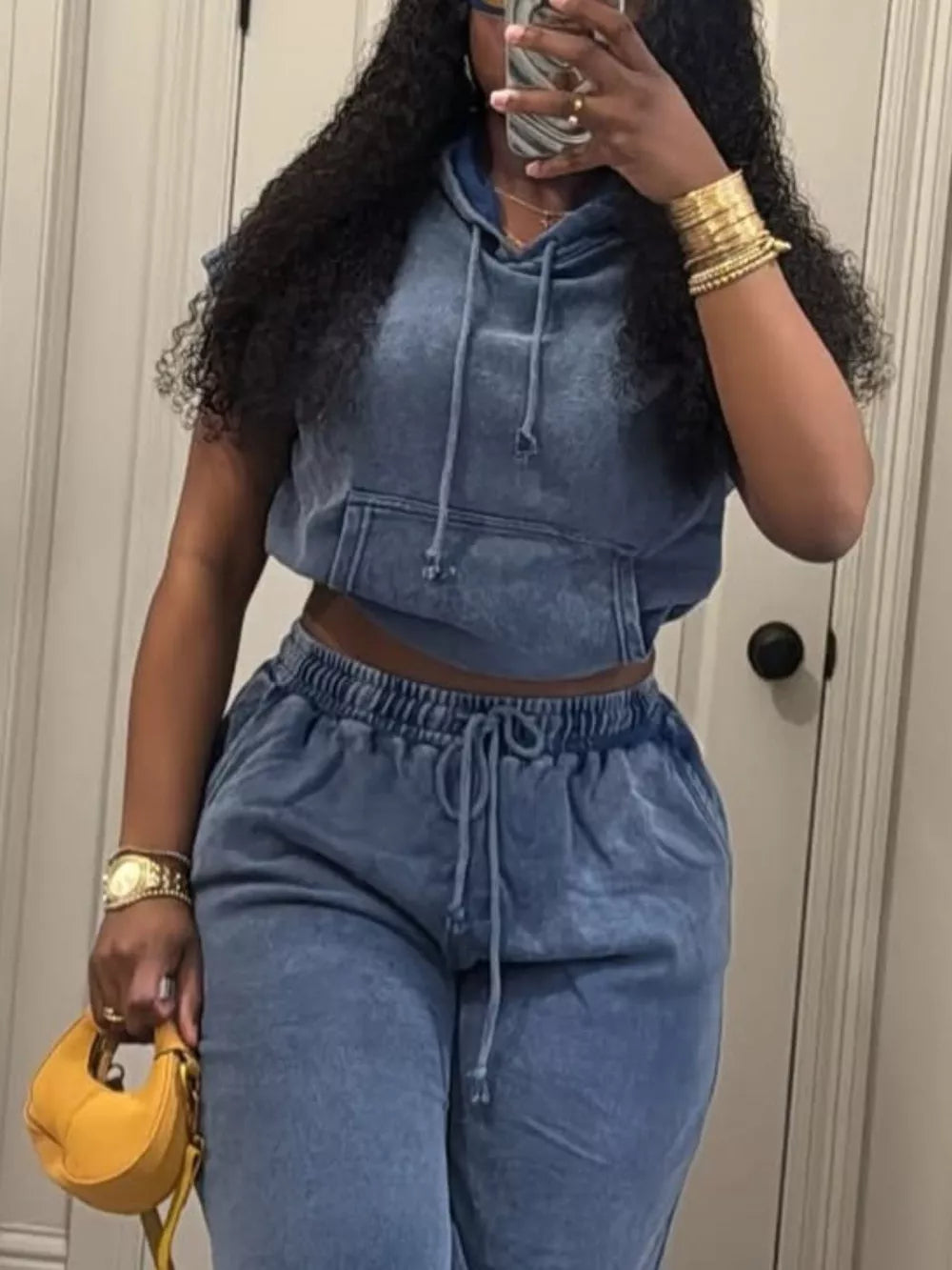 Blue hooded two-piece set with drawstring waist pants and cropped hoodie with front pocket.