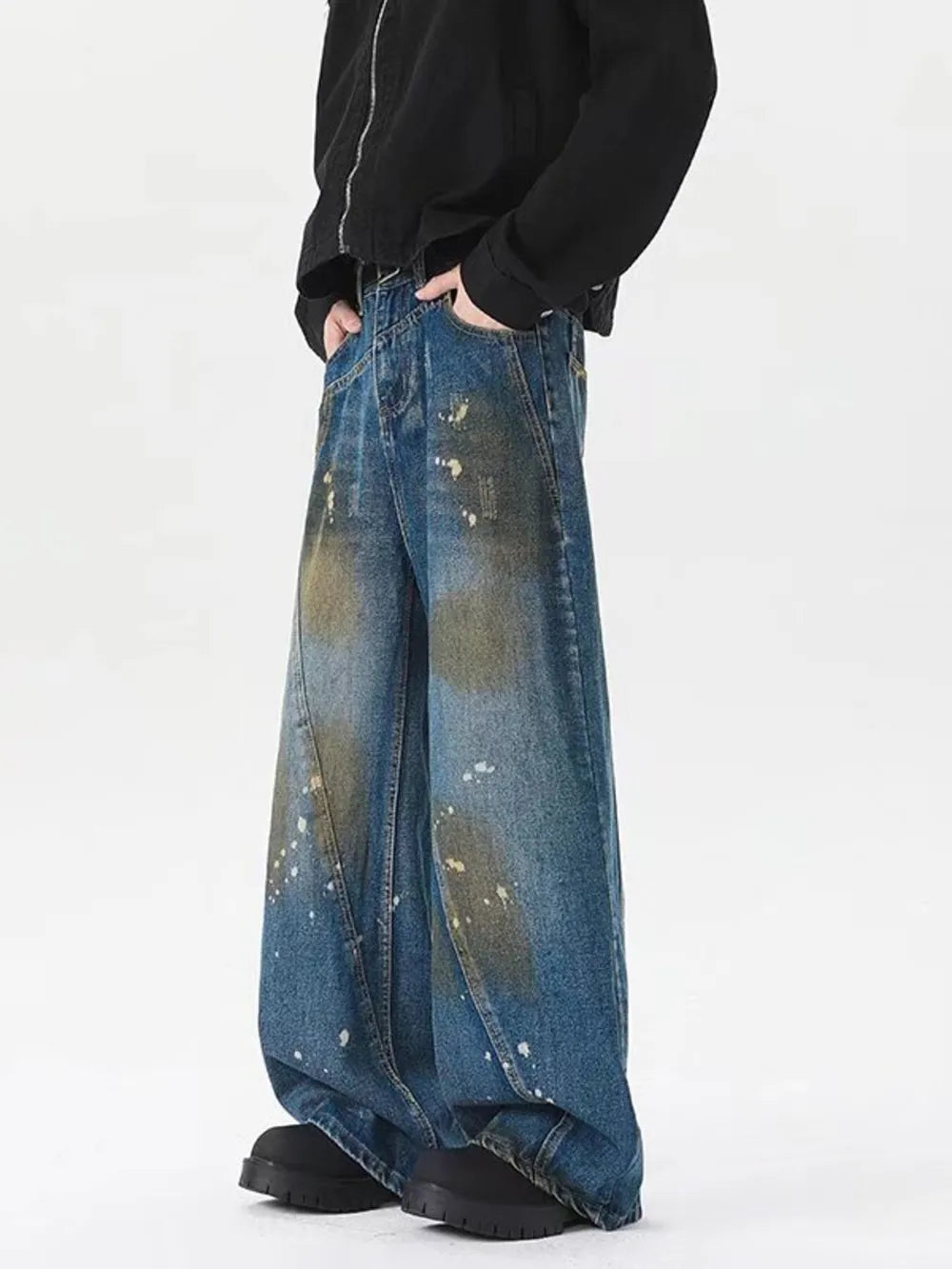 Men's plus-size wide-leg jeans in washed blue denim with paint splatter details.
