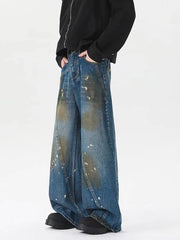 Men's plus-size wide-leg jeans in washed blue denim with paint splatter details.