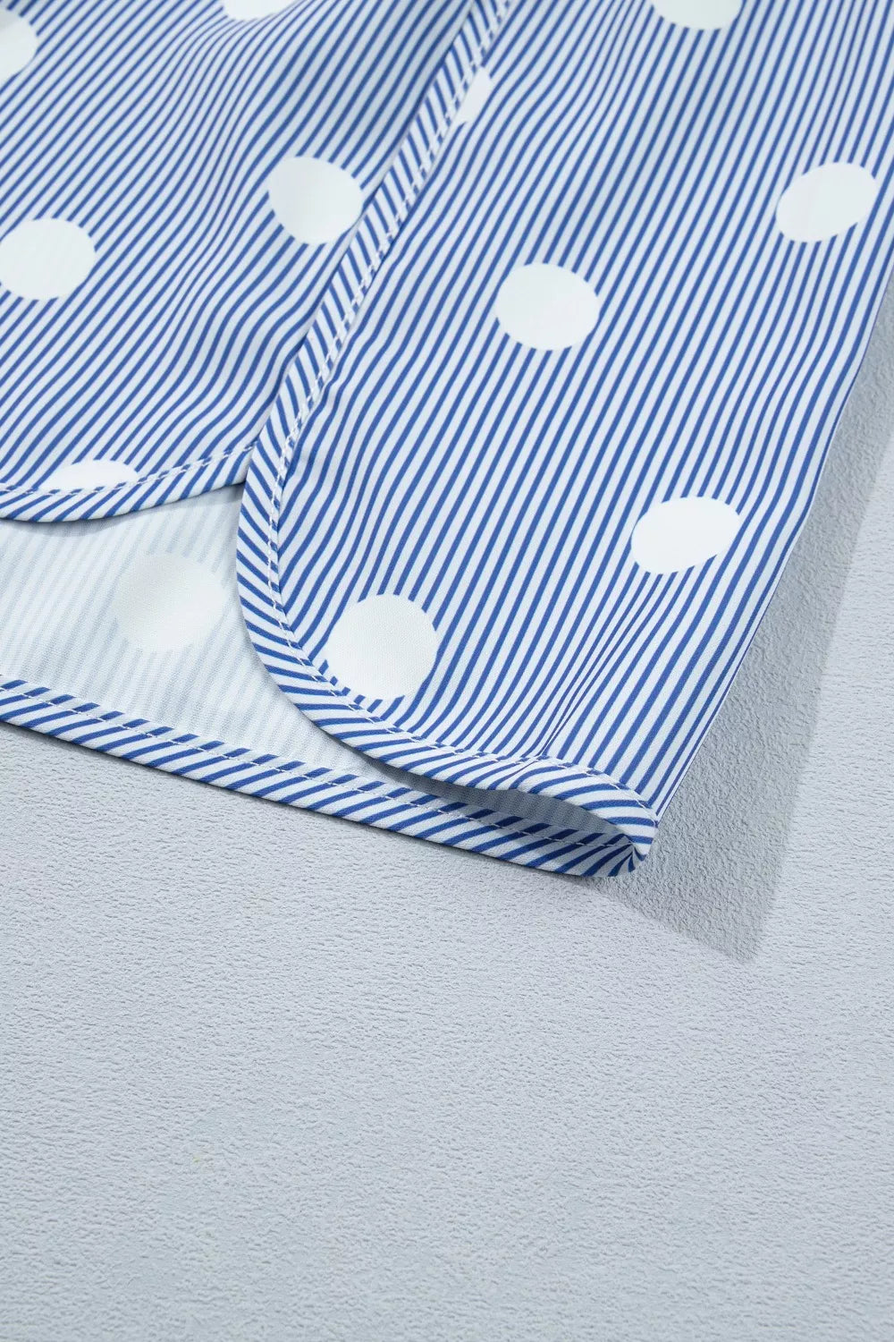 Blue and white striped polka dot shorts with a cuffed hem.