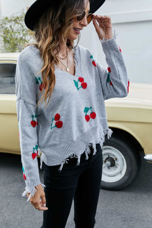 Gray knit sweater with cherry motif, V-neck, frayed hem and cuffs, long sleeves.