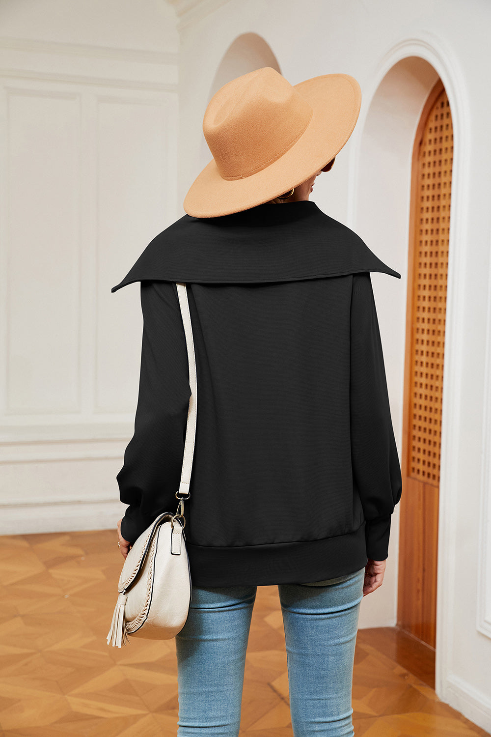 Black zip-through sweatshirt with wide collar and balloon sleeves.