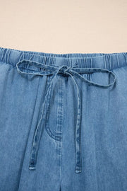 Maternity wide-leg jeans in light wash denim with elastic waistband and drawstring tie.