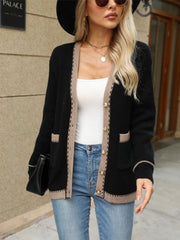 Black knit cardigan with contrast trim and gold buttons, featuring patch pockets.