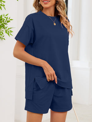 Navy blue relaxed two-piece set with crew neck tee and shorts featuring pockets.