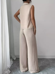 Beige sleeveless collared top and wide-leg pants set with textured fabric.
