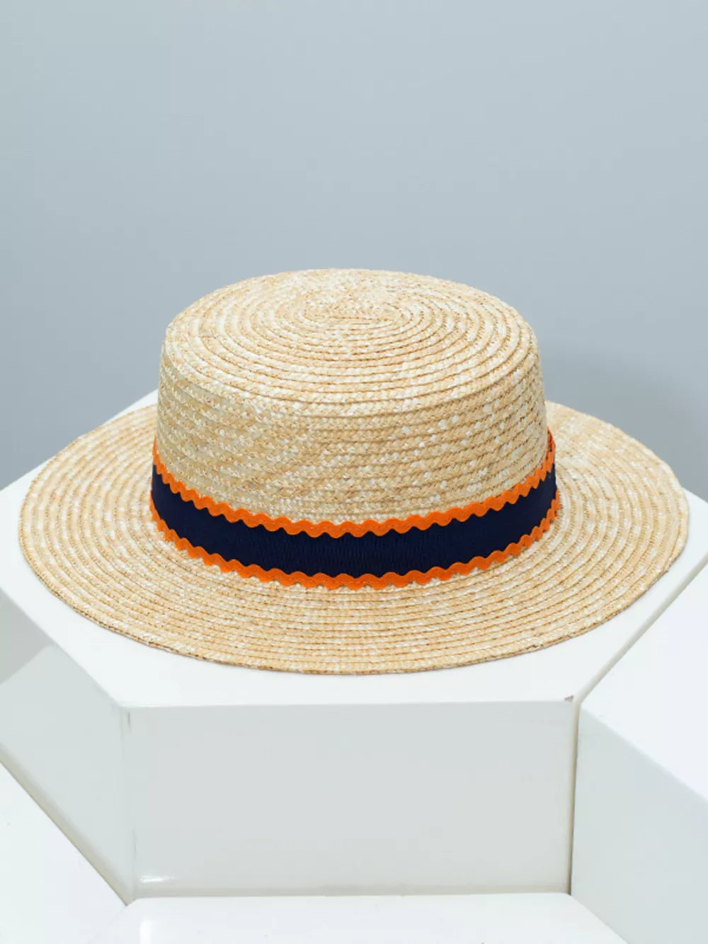 Straw boater hat with navy and orange scalloped band