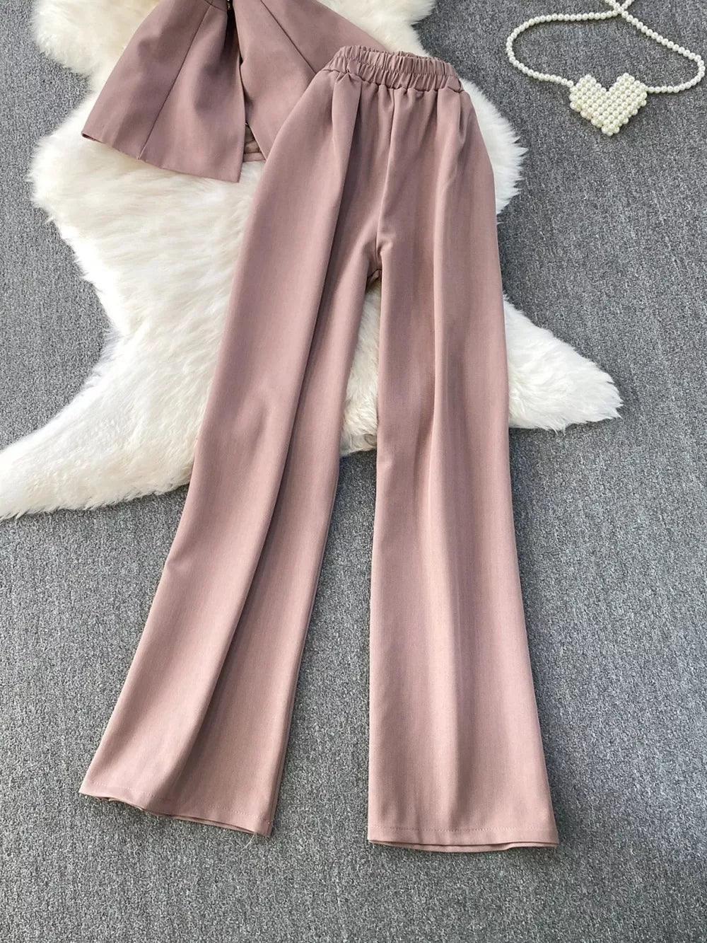 Dusty pink belted two-piece set with pockets, featuring wide-leg pants and a cropped jacket.