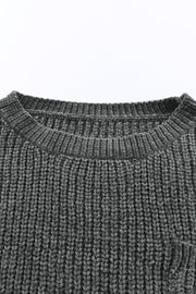 Dark gray distressed knit sweater with crew neck and visible pocket detail.