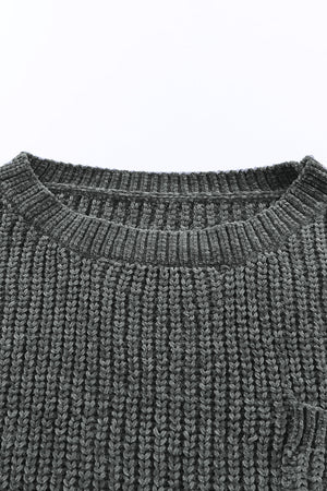 Dark gray distressed knit sweater with crew neck and visible pocket detail.