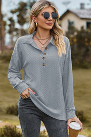 Light blue textured polo-neck sweater with button detail and long sleeves.