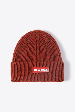 Rust ribbed acrylic beanie with New York patch
