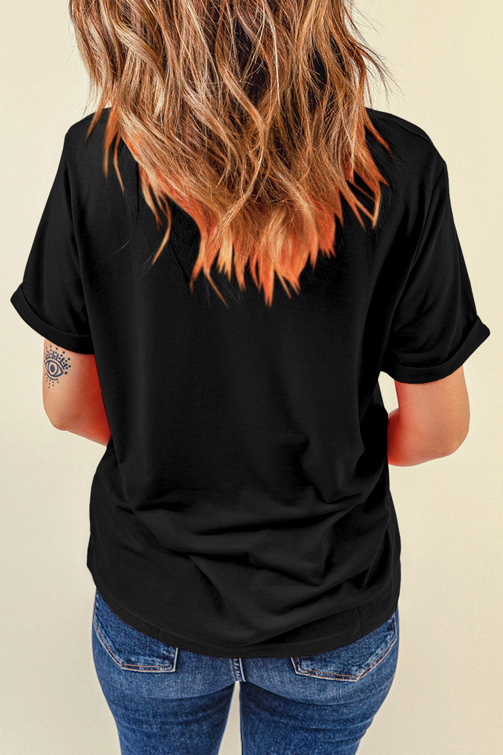 Black distressed flag graphic tee with rolled sleeves and a tattoo on the arm.