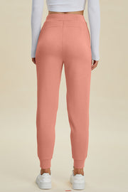 Coral joggers with a comfortable fit and cuffed ankles.