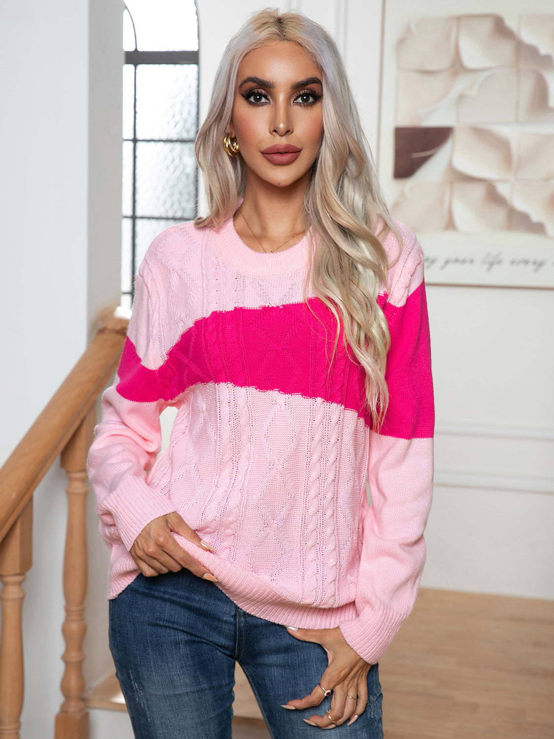 Colorblock cable knit crewneck sweater in pink and blush pink with crew neckline and long sleeves.
