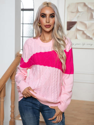 Colorblock cable knit crewneck sweater in pink and blush pink with crew neckline and long sleeves.