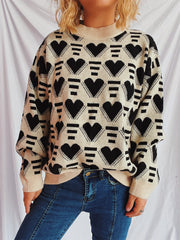 Geometric heart jacquard knit jumper in tan with black hearts and stripes pattern.