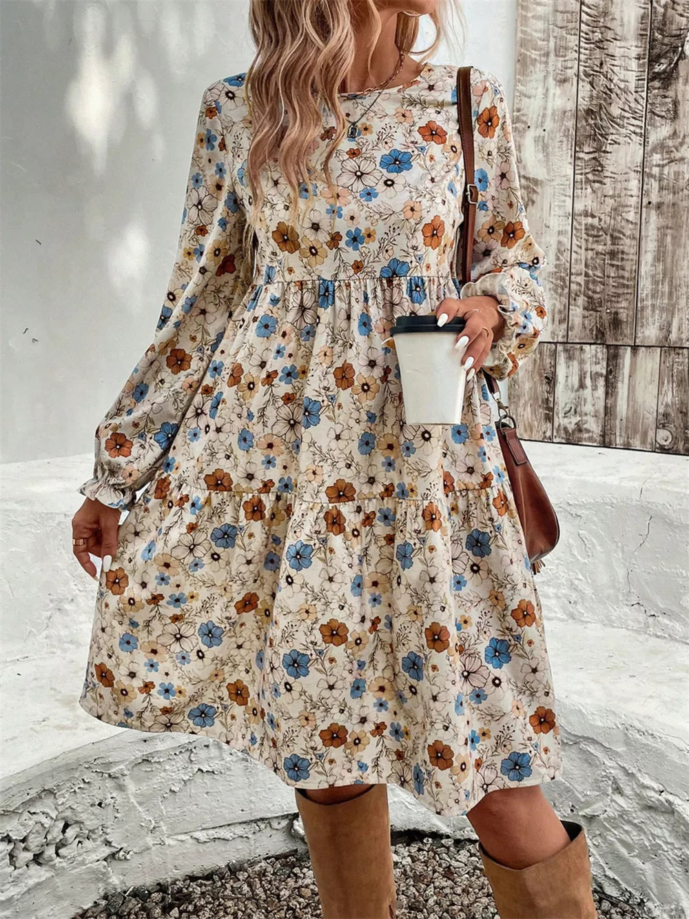 Floral tiered hem long sleeve dress with a mixed floral print in blue, brown and cream.