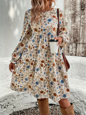 Floral tiered hem long sleeve dress with a mixed floral print in blue, brown and cream.