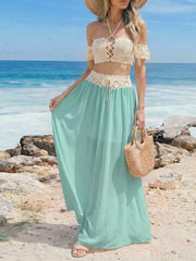 Crochet bandeau top and pastel blue maxi skirt with cutout details and lace-up front.