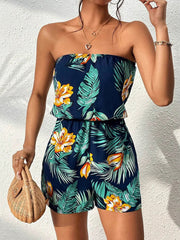 Strapless romper with tropical print, blouson waist, and pockets.